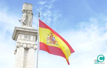 La bandera española ya ondea fente al monumento de la Constitución de 1.812.
