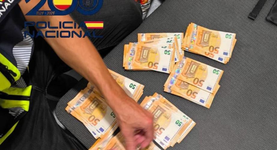 Un agente contando dinero incautado durante las acciones policiales