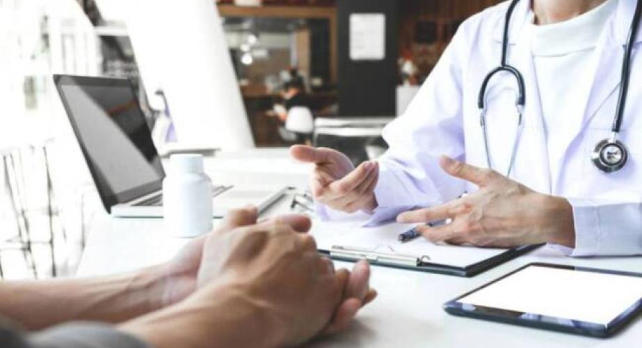 Un facultativo médico atiende a un paciente en consulta. 