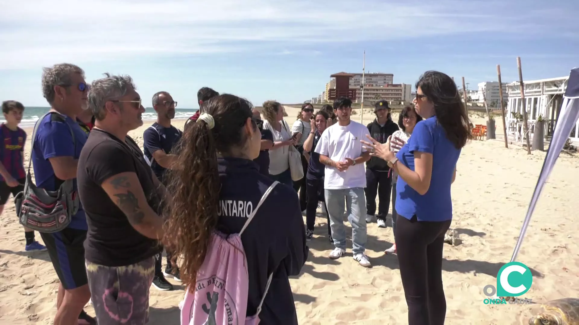 Una monitora dirige una explicación de la actividad a los voluntarios