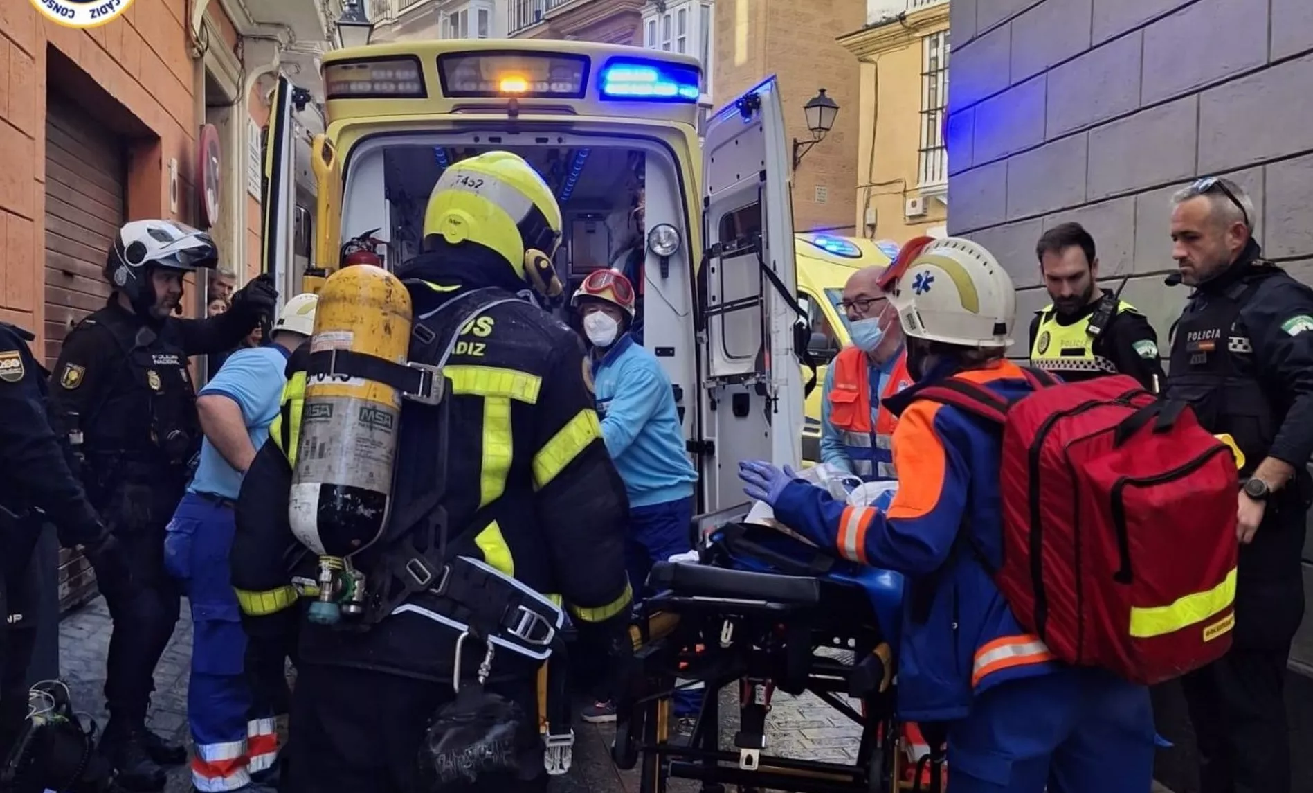 Efectivos de bomberos, policías y personal sanitario evacuando a uno de los afectados en el siniestro