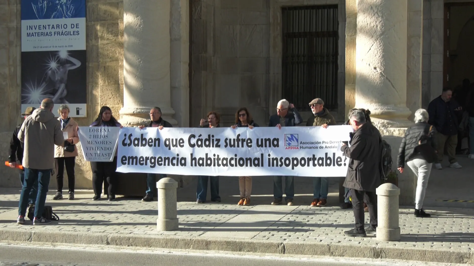 Miembros de la organización ante la puerta de entrada del edificio en la avenida Concepción Arenal